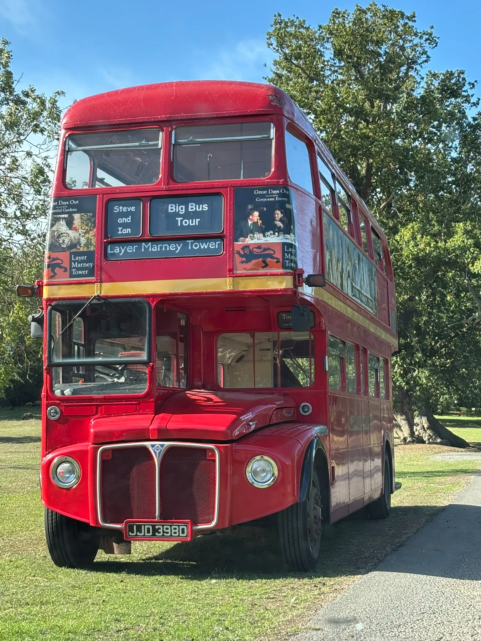 Vintage red double-decker bus parked in the grounds of Layer Marney Tower.