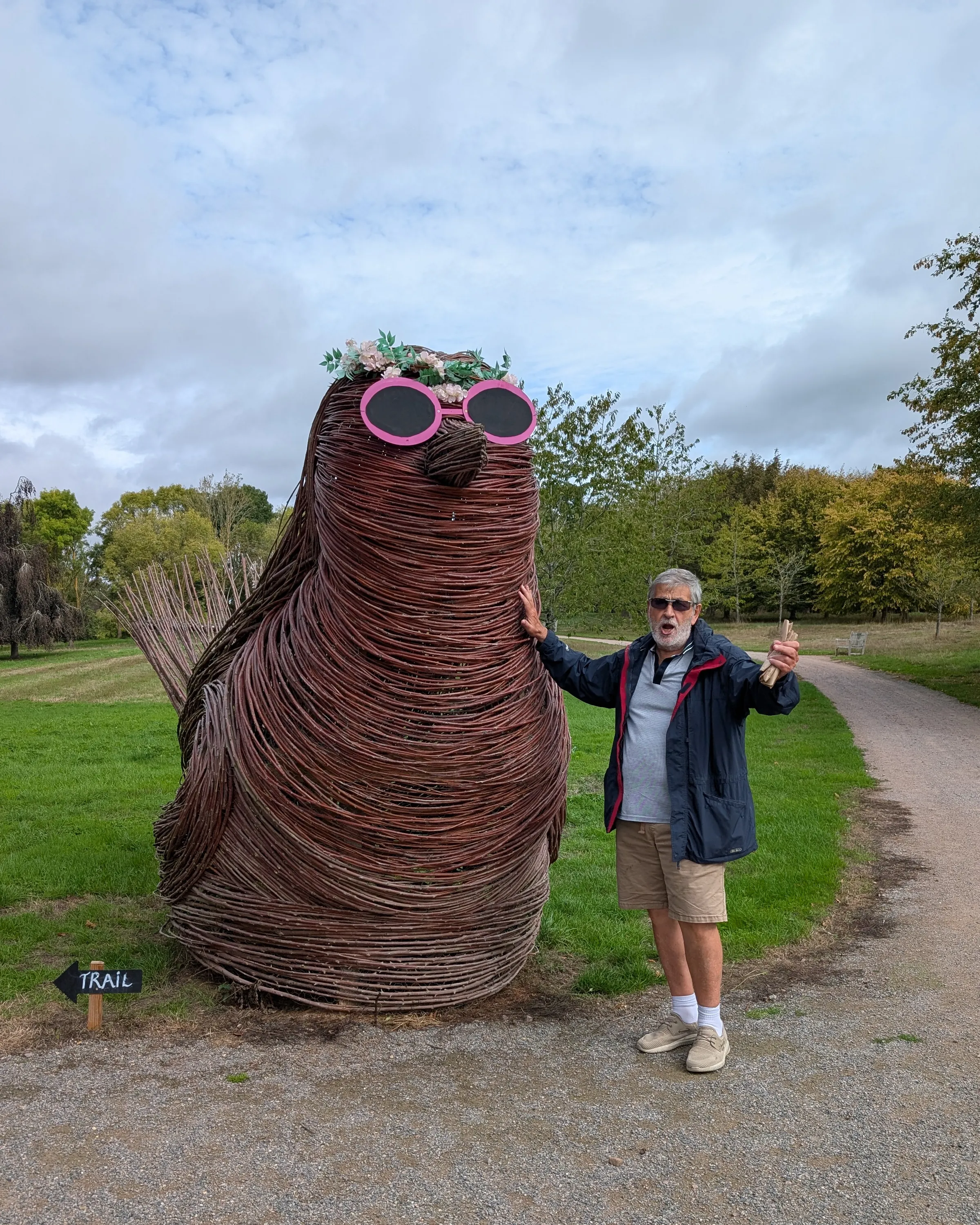 Graham standing beside a large woven animal sculpture at Markshall Estate.
