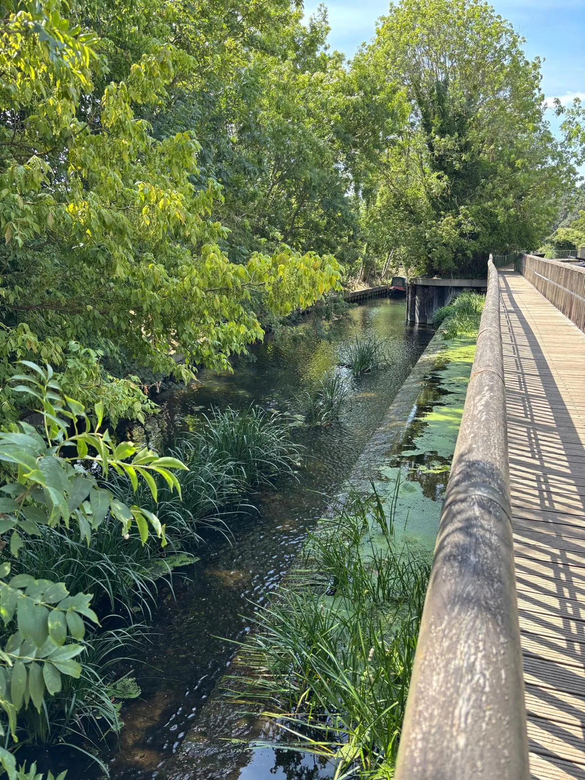 Stort Navigation beside a raised wooden riverside walkway.