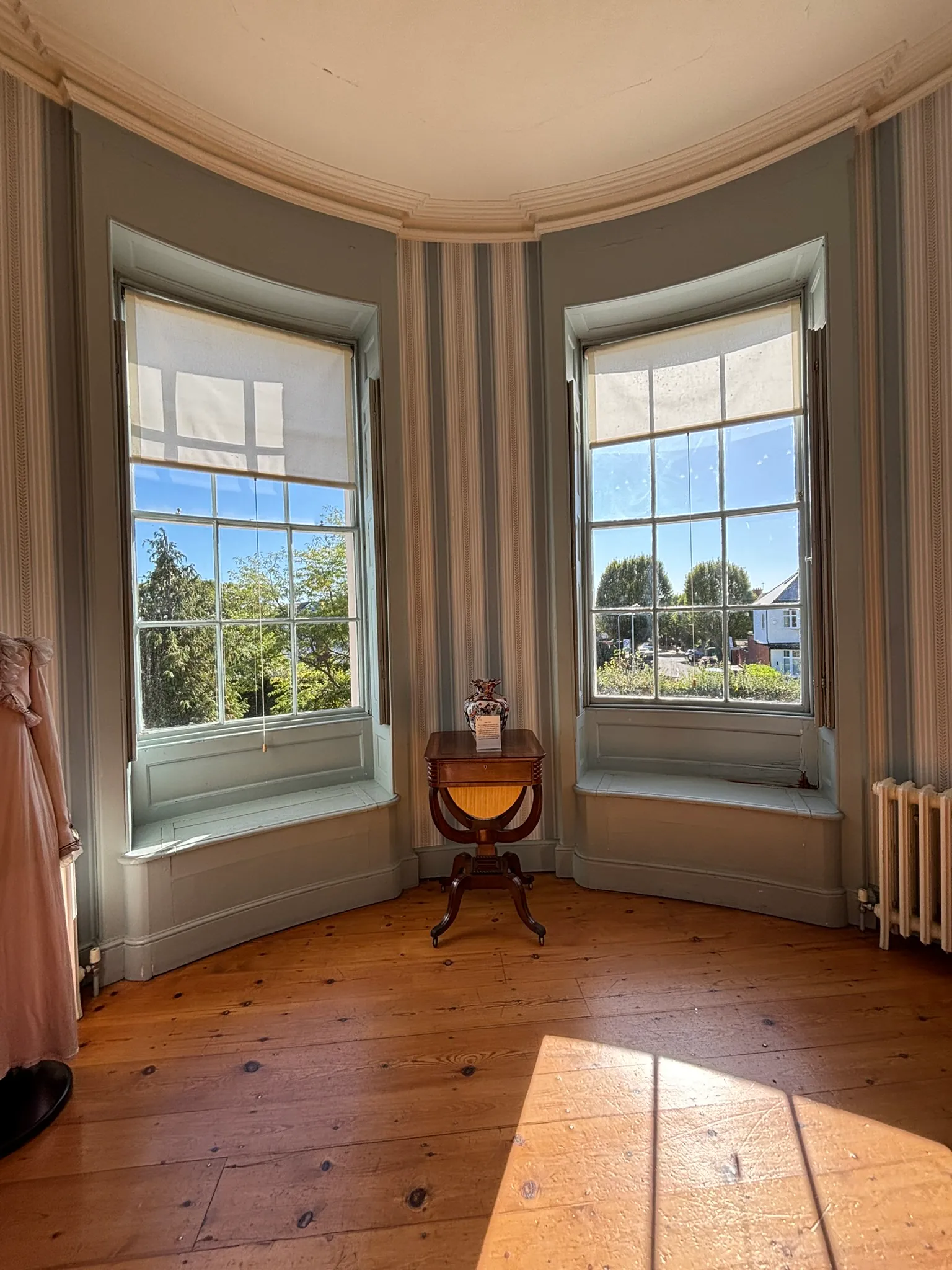 Period room with bay windows and wooden floor inside Valentines Mansion.